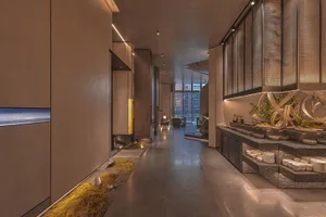 Modern open concept living space with a kitchen, dining area, and decorative vases, featuring a functional and aesthetically pleasing atmosphere