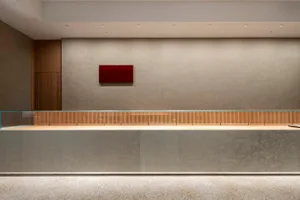 Empty lobby with a large wooden countertop, creating a warm and inviting atmosphere in a spacious room