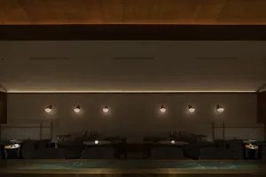A restaurant interior with multiple tables and chairs, inviting atmosphere, and cups on some tables