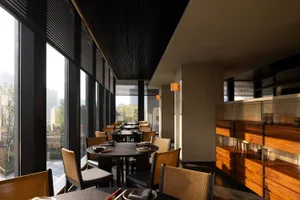 Inviting restaurant interior with tables, chairs, and natural light from a large window