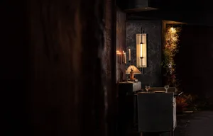 A cozy dining area with a table set for dinner, chairs, and a warm atmosphere