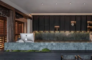Modern kitchen with a black countertop, two sinks, a clock on the wall, and a computer monitor on display