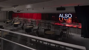 Modern restaurant interior with multiple dining tables and chairs, couches, and a welcoming atmosphere