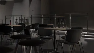 A dark and moody restaurant with several tables and chairs, well-organized and inviting, but empty and lacking natural light