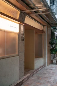 Two modern rooms with glass walls, potted plants, and a well-designed interior