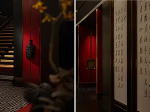 A modern hallway with red walls, a black vase, and a floor plan layout including doors and windows