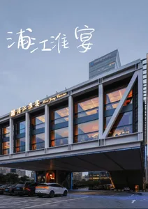 Modern building with a large glass facade featuring many windows, allowing natural light to enter the interior