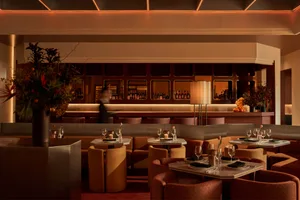 Sophisticated dining space with wooden furniture, wine glasses, and a comfortable atmosphere