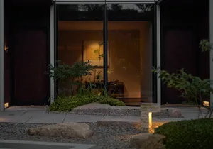 Cozy indoor living area with two couches, a potted plant, and a glass door leading to a patio