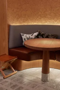 Cozy living space with a sofa, dining table, and chairs, featuring a warm and inviting atmosphere