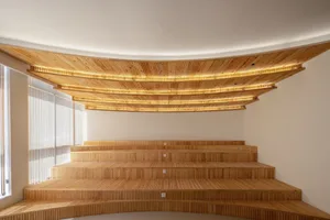 Empty auditorium with wooden benches in rows, creating a calm and quiet atmosphere