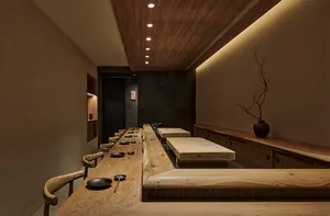 Empty restaurant kitchen with wooden tables and chairs, sinks, and a focus on practicality and organization