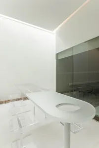 Empty modern bathroom with a glass sink in the center, giving a clean and minimalist appearance