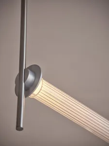 A dimly lit room with a long silver pole extending across its width, with no other objects or details visible