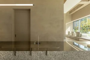 Modern kitchen with metal sinks and marble countertops, featuring a sleek and contemporary design