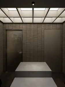 Rustic living space with brick walls, a metal table, and a doorway leading to another room