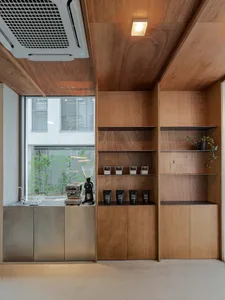 Wooden room with wood paneling, bookshelves, and cups, creating a warm and cozy atmosphere