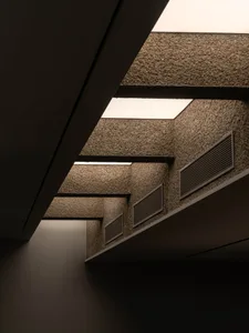 Modern interior space with air conditioning vents, multiple windows, and a functional design