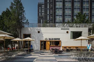 Outdoor seating area with tables, chairs, and umbrellas, perfect for a coffee shop