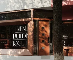 A photo of a brown building with a wooden door and window, giving it a warm and earthy appearance