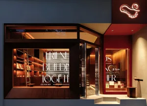 A well-organized bookstore with wooden shelves, natural light, and various books on display