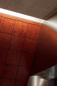 A modern and minimalist space with wooden walls and ceiling, featuring a combination of interior and exterior elements, with possible natural light from windows or skylights