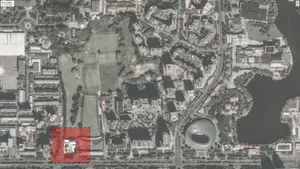 Aerial view of a city with various buildings and structures in different styles, showcasing concrete as a prominent material in a bustling urban environment