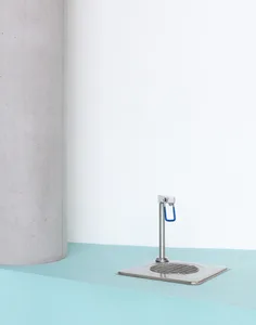 A clean and organized bathroom with a white sink and countertop, featuring a silver faucet and drain, against a wall