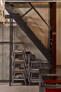 Industrial staircase with metal steps and a concrete wall in a building