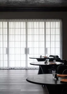 A clean and well-organized restaurant with multiple dining tables and chairs, ready for customers