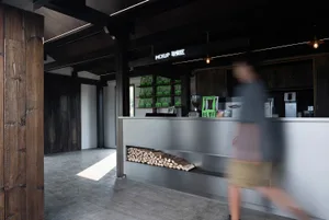 Cozy casual dining space with a wooden counter, chairs, and a fireplace, creating a warm atmosphere