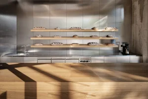Warm and inviting kitchen with wooden cabinets, countertops, and ample storage space for food items, featuring an oven and sink
