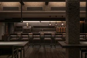 A warm and inviting restaurant kitchen with wooden floors, black countertops, and various appliances, set up for guests to enjoy meals