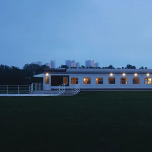 A modern building with a living area and dining area, lit by natural light and featuring clean lines and minimalistic elements
