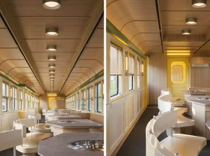 Modern train car dining area with multiple tables and chairs, decorative items, and a comfortable atmosphere