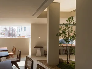 Inviting restaurant dining space with chairs, a dining table, and potted plants