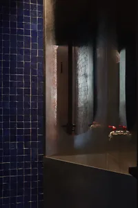 Modern bathroom with a glass shower, dual sinks, and well-lit design