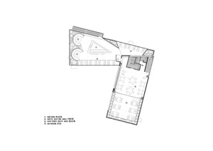 Black and white floor plan of a hotel with various rooms, including a dining area, lounge, and possibly a bar or meeting room