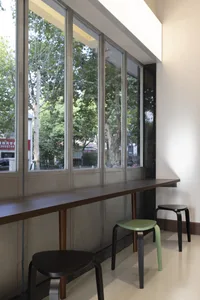 A rendered room with a large window, two chairs, and a bench, providing a comfortable and inviting atmosphere