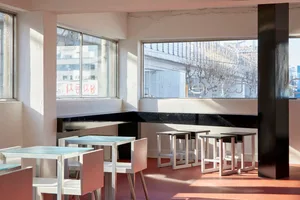 A clean and organized restaurant interior with multiple dining tables and chairs, ready for customers
