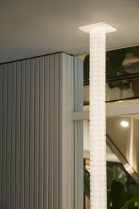 Contemporary indoor space with a metal staircase, potted plants, and modern decor