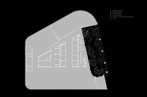 2D floor plan of a modern building with a mix of residential and commercial areas, featuring clean lines, minimalistic design, and predominantly concrete and glass materials