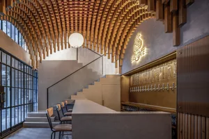 Cozy bar with wooden walls and ceiling, featuring comfortable seating and a warm atmosphere