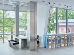 Bright and inviting open concept kitchen and dining area with a large window, dining table, and additional workspace