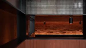 Empty auditorium with wooden walls and flooring, creating a warm and inviting atmosphere with clear lines and minimal decoration