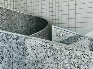 A modern staircase with concrete steps and metal railings, featuring a sleek and contemporary design