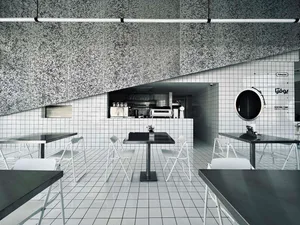 Empty restaurant interior with white tables and chairs, clean and well-organized, ready for customers