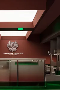 A modern restaurant interior with a red wall, green ceiling, and a counter with a logo, featuring two sinks and a refrigerator in a warm and inviting atmosphere