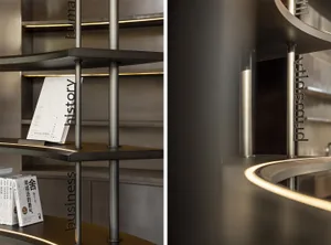 A well-organized space with a metal bookshelf displaying books on multiple levels, creating a functional reading and storage area