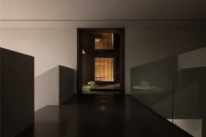 A calm and inviting entrance hallway in a modern building with a glass wall, two benches, and a dark background
